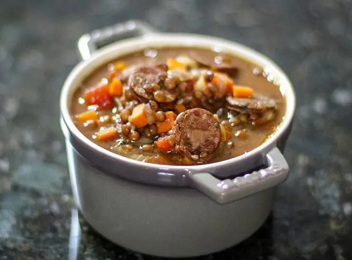 lentil and sausage soup in a small bowl