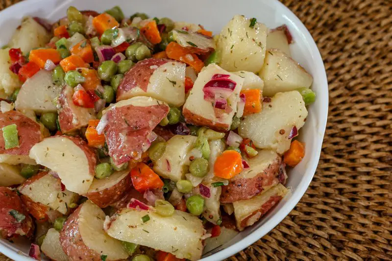 light potato salad in a serving bowl