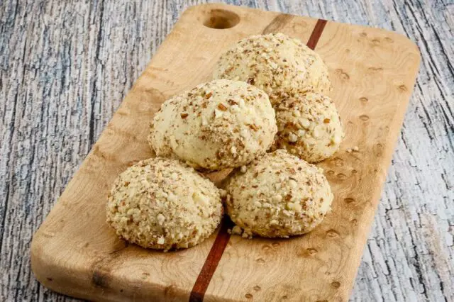 macadamia nut cookies on a small cutting board