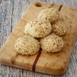 Macadamia nut cookies on a small cutting board