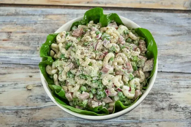 macaroni salad with ham in a serving bowl