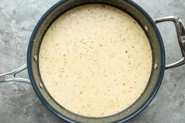 adding the milk to the Maine haddock chowder