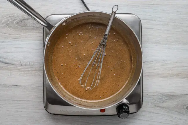 The glaze mixture is whisked over medium heat until hot and smooth.