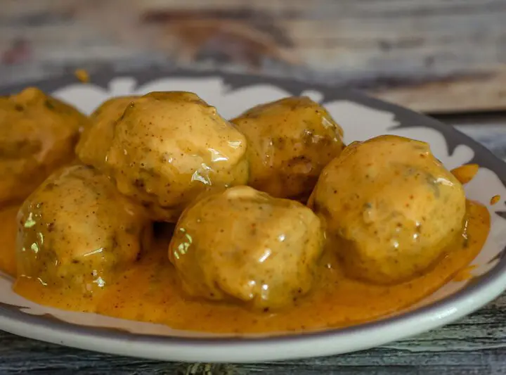 spicy tex-mex meatballs with cheese sauce on a plate