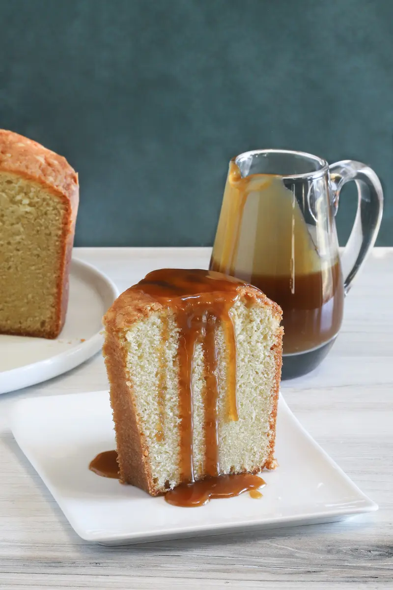 A slice of million dollar pound cake, a buttermilk pound cake with a caramel sauce drizzle.