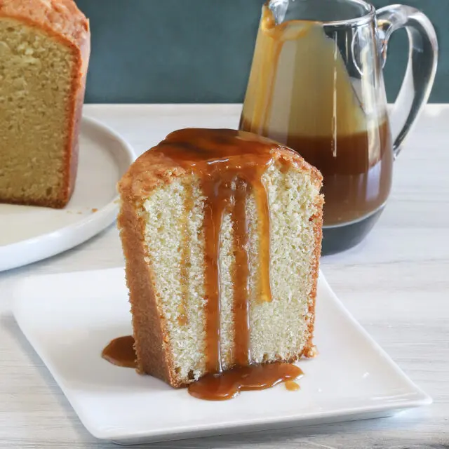 A slice of million dollar pound cake, a buttermilk pound cake with a caramel sauce drizzle.