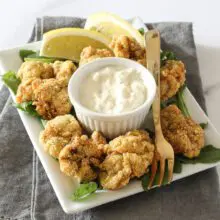 fried oysters with remoulade and lemon wedges