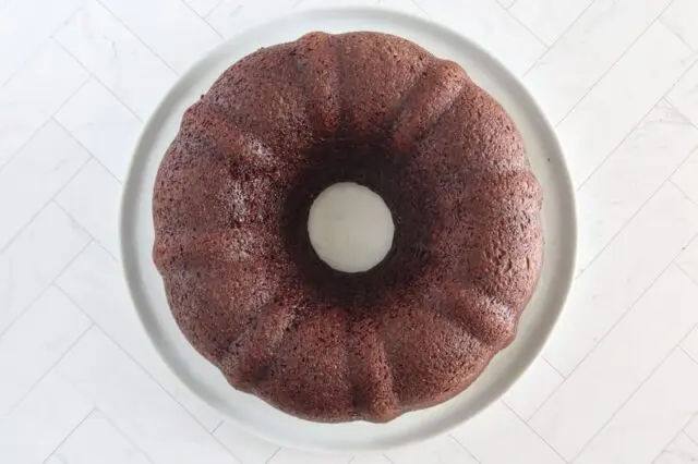 The chocolate cake inverted onto a cake plate.