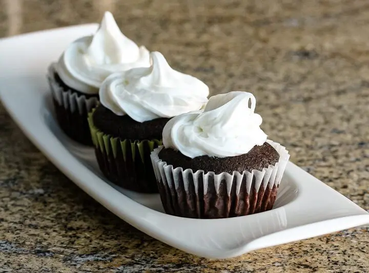 Moist chocolate cupcakes on a serving tray.