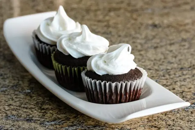 Moist chocolate cupcakes on a serving tray.