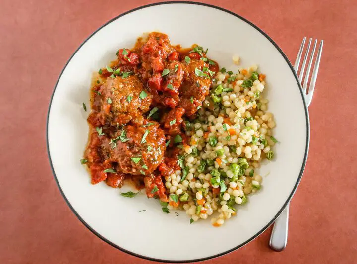 moroccan meatballs on a plate with couscous