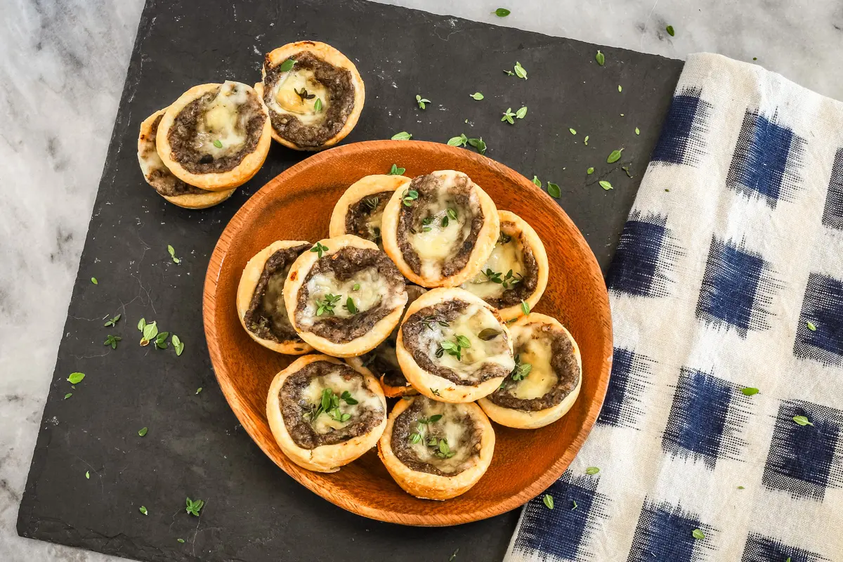 Tartlets with cream cheese pastry filled with mushroom duxelles and fontina cheese.