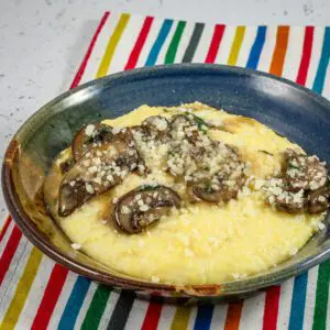 Sautéed mushrooms over polenta with a sprinkle of Parmesan cheese.