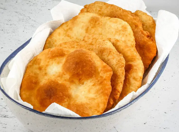 Native American fry bread in a serving bowl with paper towels.