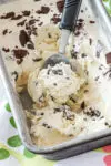 Easy no churn ice cream with a scoop in a loaf pan.