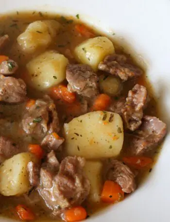 A bowl of old-fashioned beef stew with vegetables.