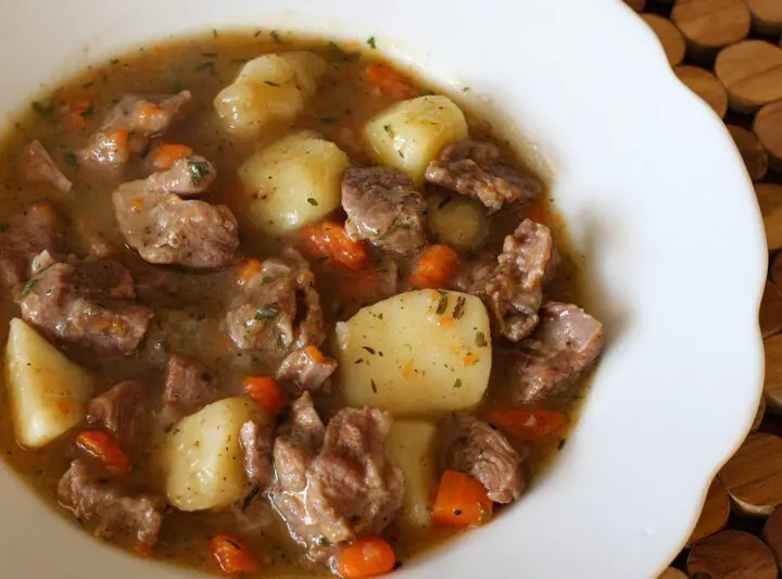 A bowl of old-fashioned beef stew with vegetables.