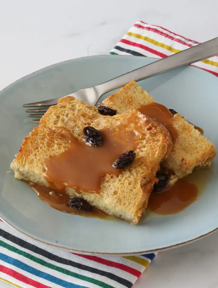 old-fashioned bread pudding on a plate with caramel sauce