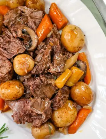 a pot roast with potatoes, carrots, and onion soup