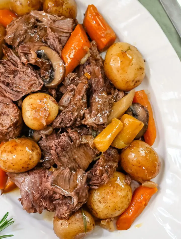 a pot roast with potatoes, carrots, and onion soup