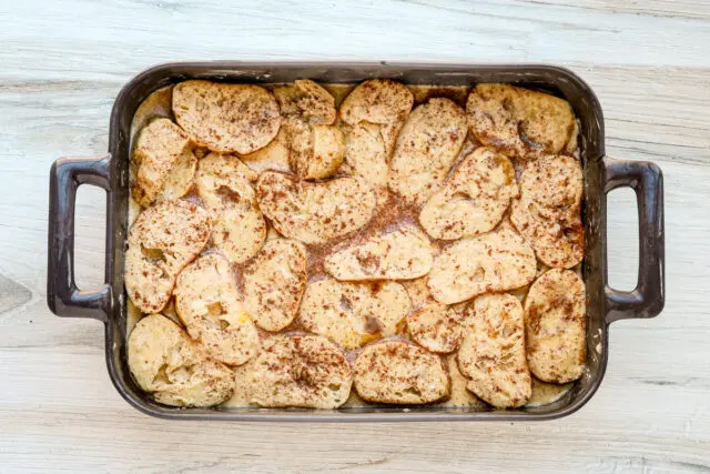 The bread slices are soaked in the cinnamon and vanilla flavored milk mixture.