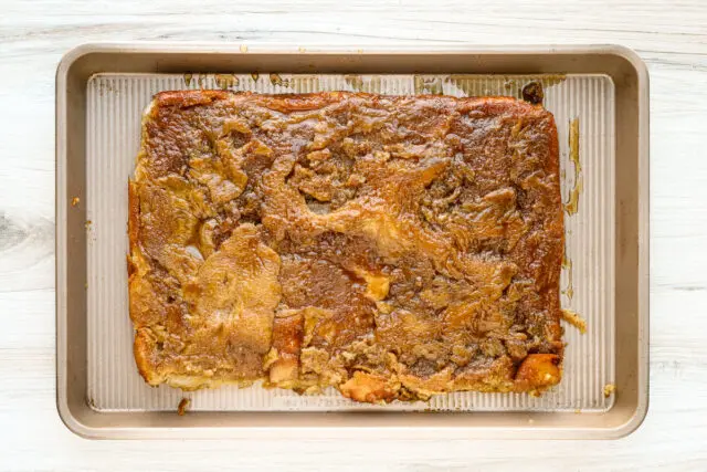 The overnight French toast is flipped over for serving, showing the moist brown sugar underside.