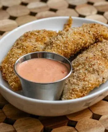 bacon and panko coated chicken tenders on a plate with dip
