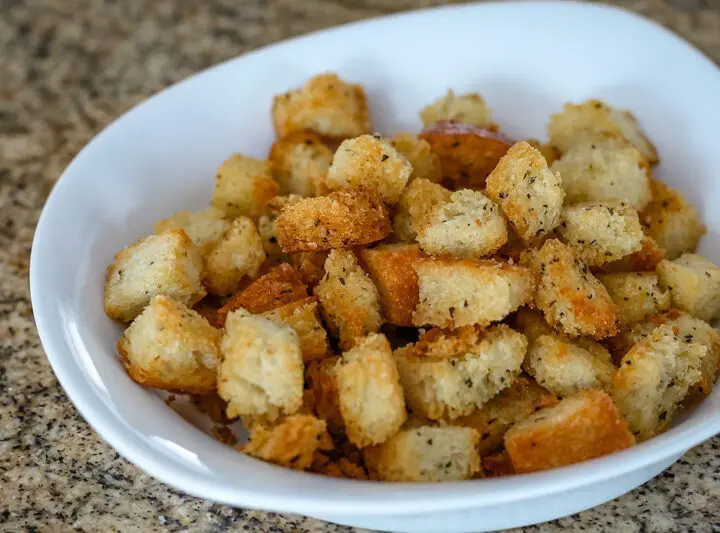 Seasoned croutons in a small bowl.