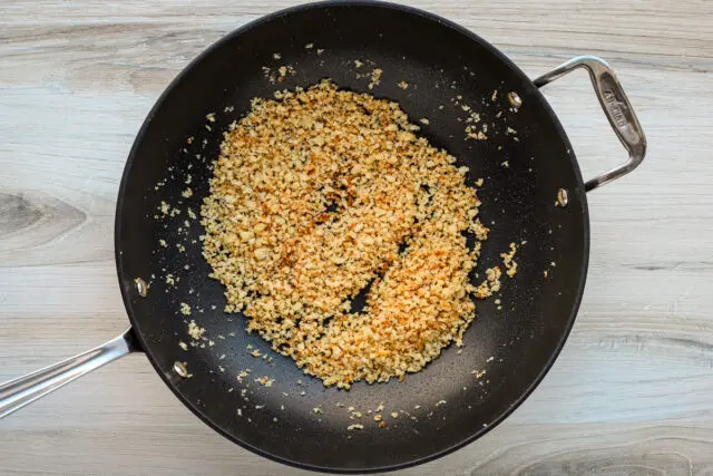 Browning the panko breadcrumbs with butter, olive oil, garlic, and lemon zest.