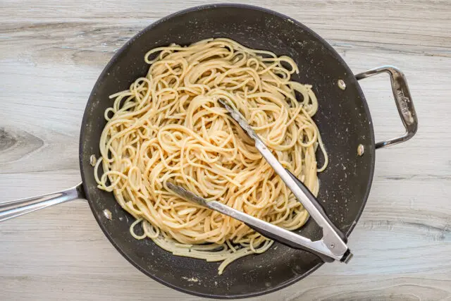 Tossing the spaghetti in the hot browned anchovy butter.