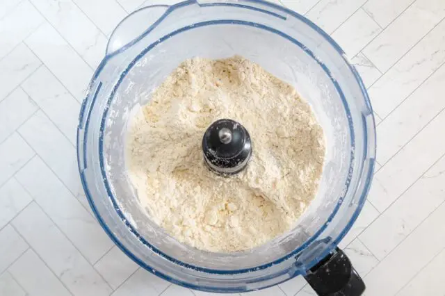 pieces of butter are visible in the processed crust mixture