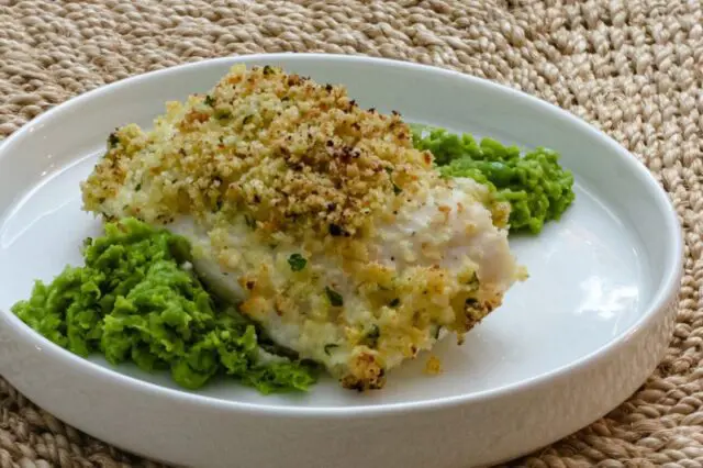 pea puree on a platewith a halibut filet