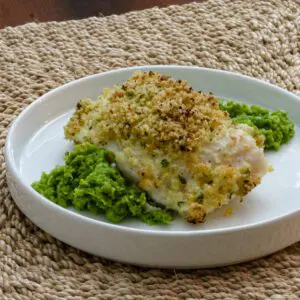 a crusted halibut filet served over pea purée