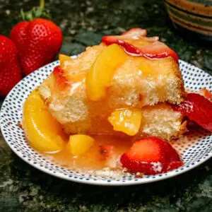 a slice of sponge cake with strawberry peach dessert sauce