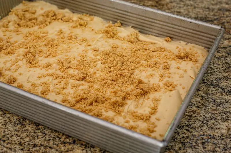 Peanut butter crumb cake preparation: the cake batter in the pan and crumb topping.