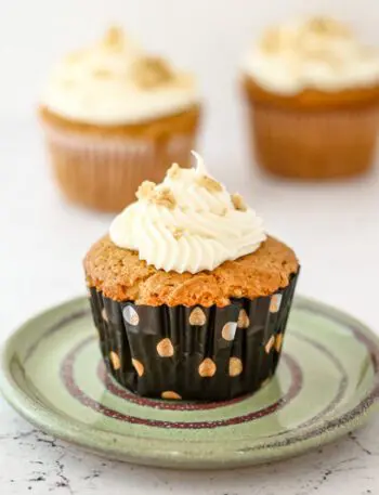 a peanut butter cupcake on a small plate, frosted