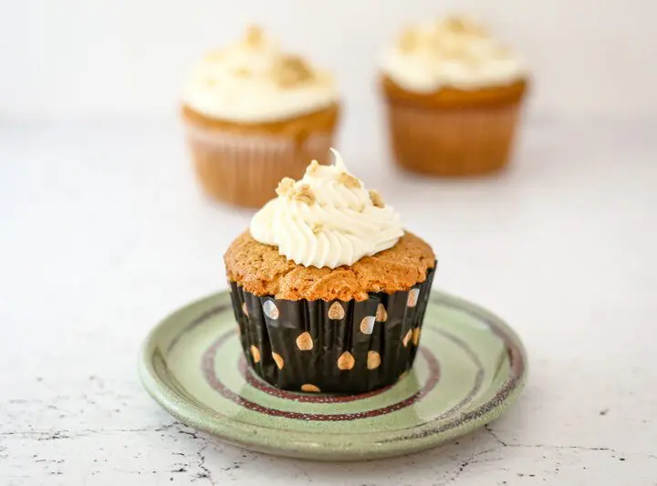 a peanut butter cupcake on a small plate, frosted