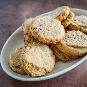 a plate of peanut butter cookies with mini chocolate chips and chopped peanuts