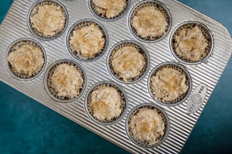 pear muffin batter in the muffin pan, ready to bake