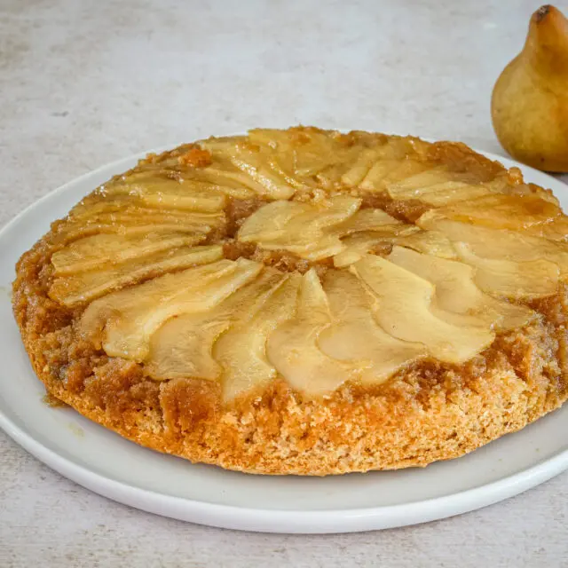 Pear upside-down cake on a plate.