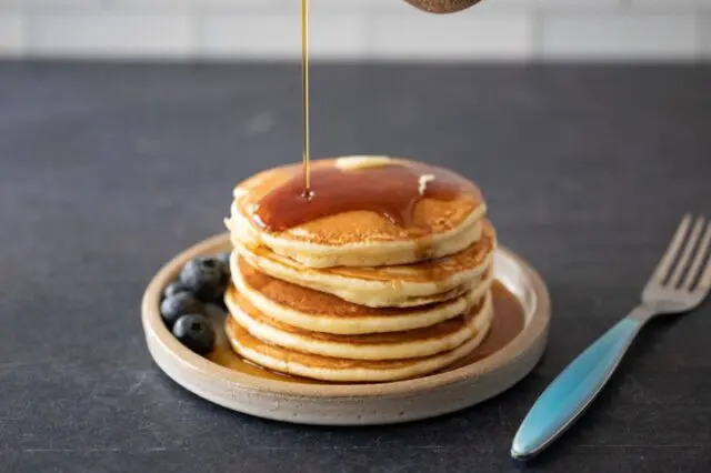 pancakes on a plate with maple syrup