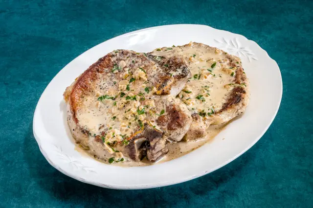 pork chops with pan sauce on a platter