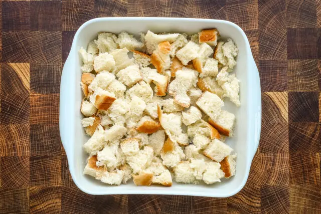 Leftover dinner rolls or bread torn and layered in the baking dish for French toast casserole.