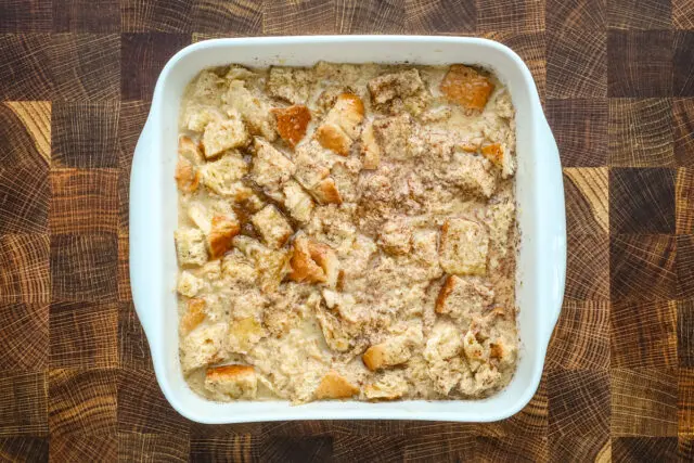 A baking dish with French toast casserole, ready to go into the oven.