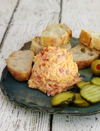 pimento cheese plate with pickles and baguette slices