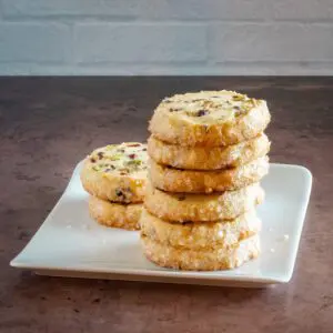 a stack of pistachio cranberry shortbread cookies