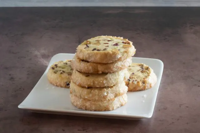 A stack of pistachio cranberry shortbread cookies