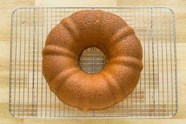 Pistachio bundt cake cooling on a rack.