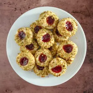 A plate of pistachio thumbprint cookies