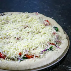 bread machine pizza crust with toppings, ready to bake